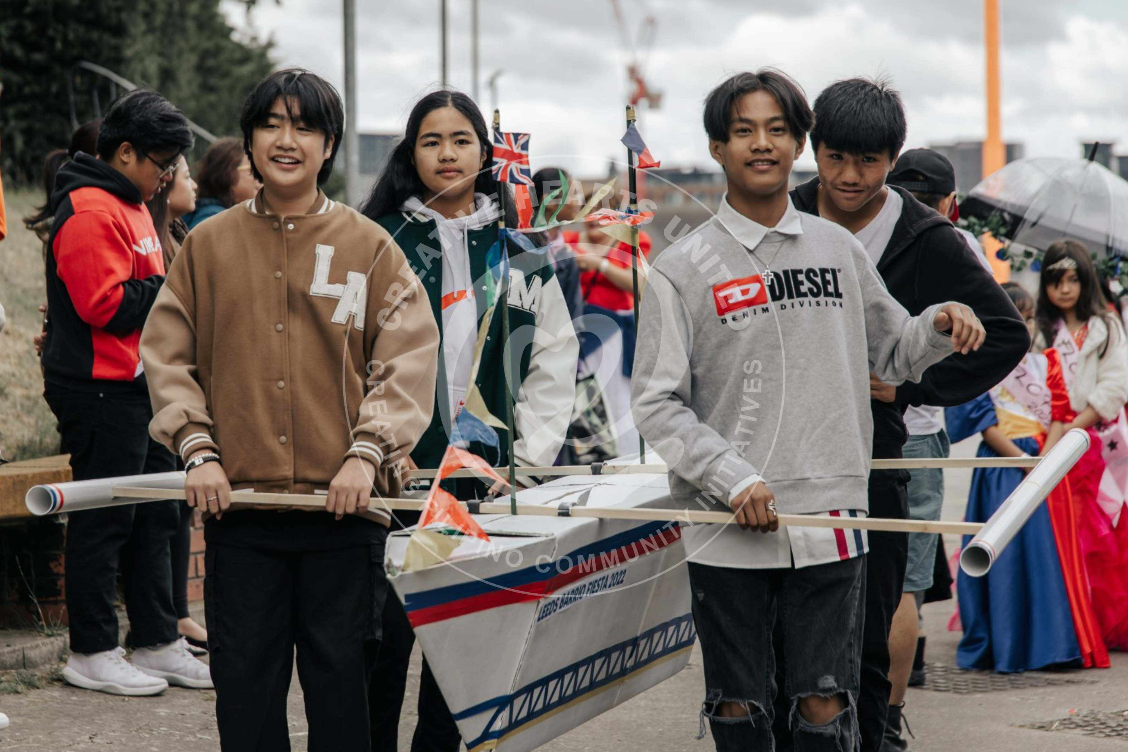 Creative Hearts United. "Iisang Bangka Tayo” (We're all in one boat) serves as a poignant reminder of the enduring spirit of unity that unites the Filipino community, even in the face of adversity. The miniaturise boat was created by Ronald Chu.