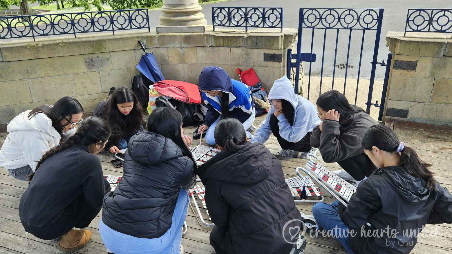 A typical rehearsal at the park, NJr Drum & Lyre Corps sheltering from a drizzle at Lister Park Bandstand