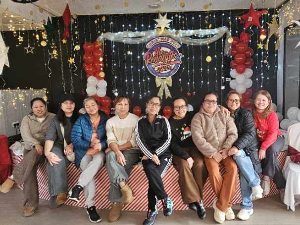 Festive hands at work — the Renalytes transform the stage for their celebration.