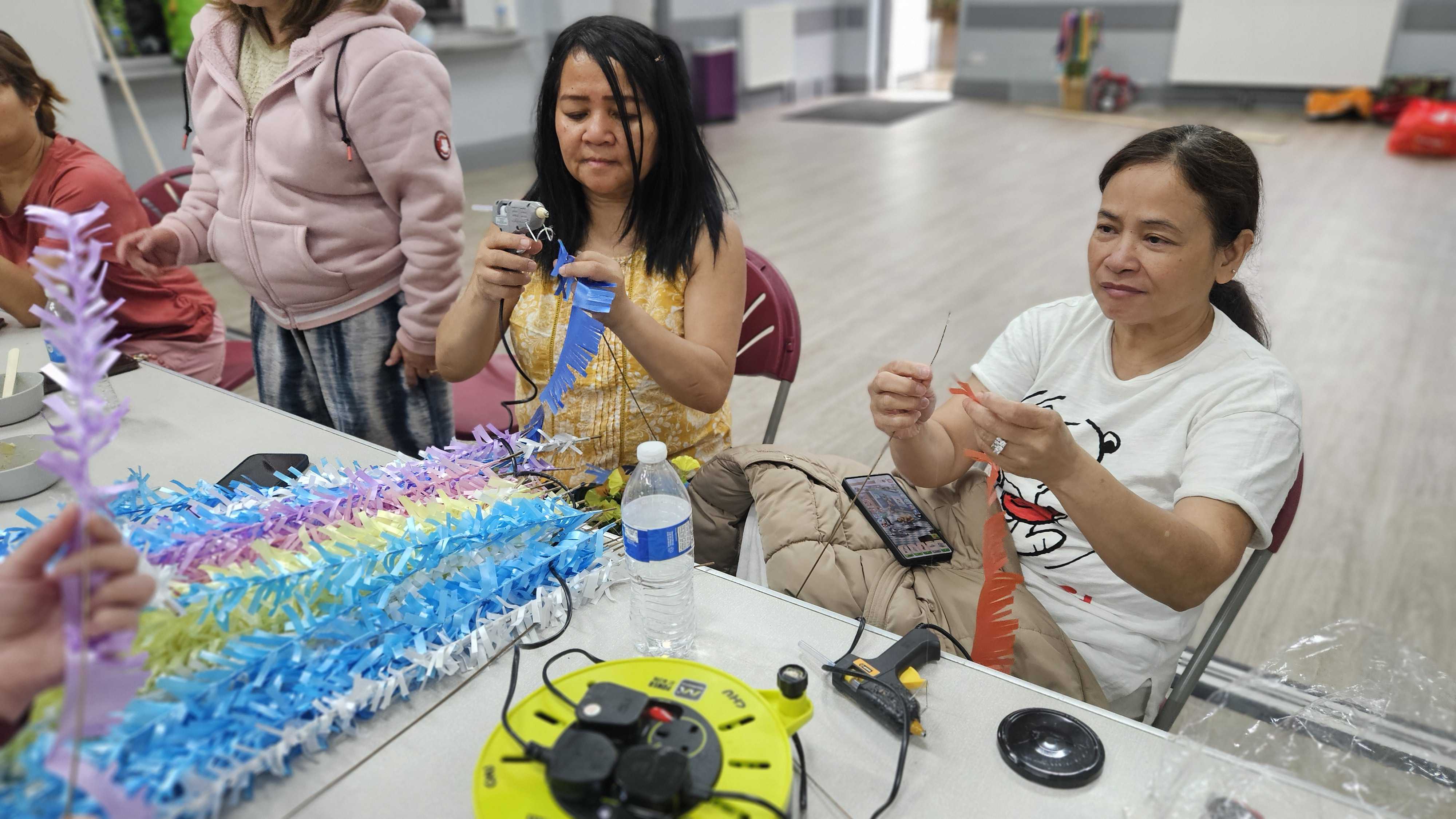 Making folk dance props brings back fun high school memories for our volunteers.