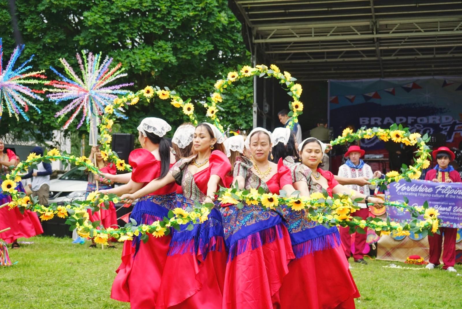 Performers lift their floral arches high, creating the signature Bulaklakan circle that celebrates unity and festivity.